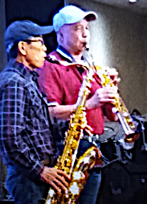 duo saxaphone players, one a tenor sax and the other a soprano sax